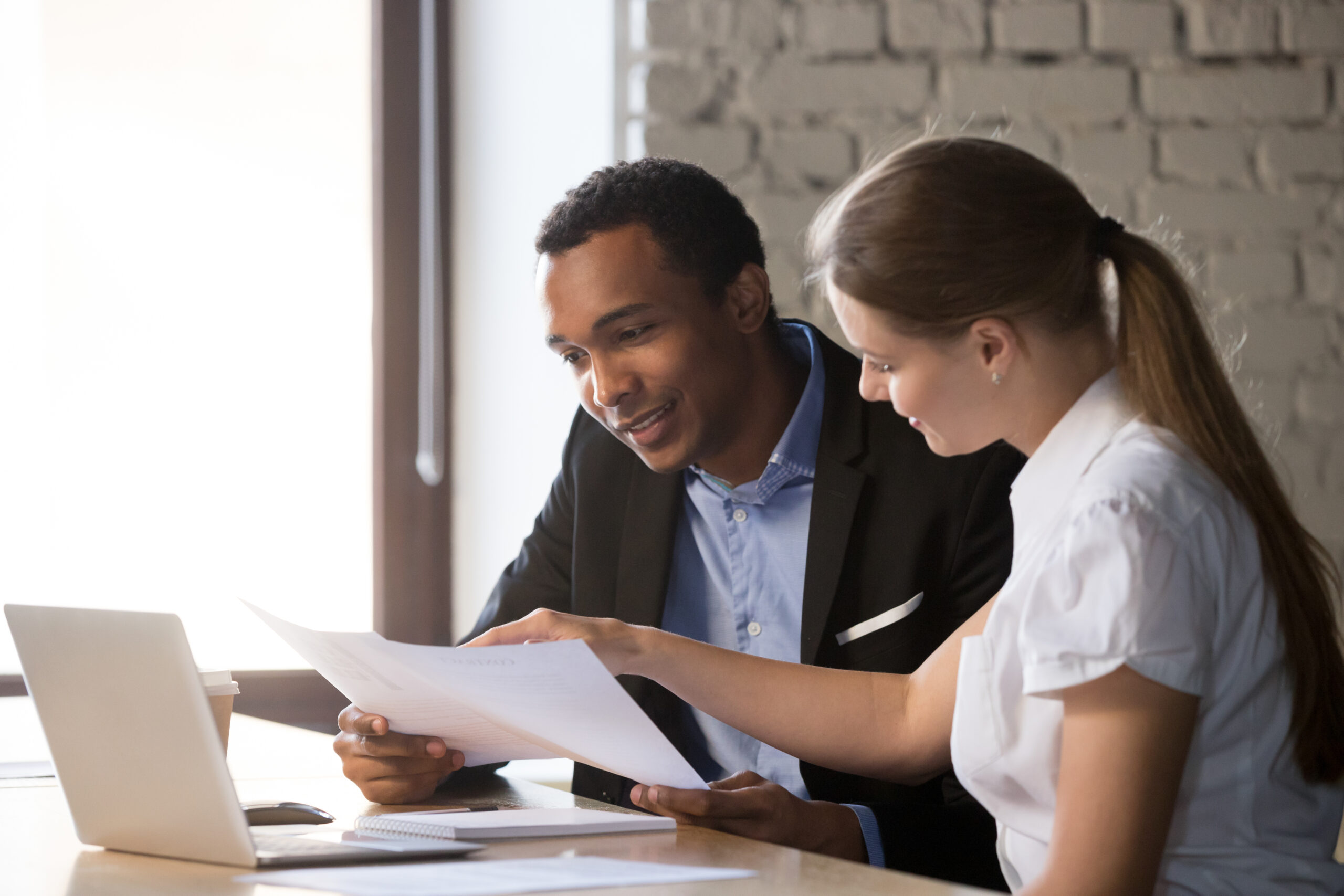 female financial advisor insurer consulting male african america